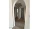 Hallway with arched entryways to bedrooms at 8520 W Palm Ln # 1021, Phoenix, AZ 85037