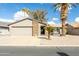 Front view of single story home with garage and palm trees at 949 S 79Th Way, Mesa, AZ 85208