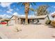 Single-story home with desert landscaping and a large palm tree in the front yard at 949 S 79Th Way, Mesa, AZ 85208