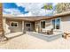 Cozy patio area with shade sail, wicker furniture, and gravel ground at 949 S 79Th Way, Mesa, AZ 85208