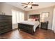 Guest bedroom with a queen bed and wood floors at 9943 E Sunridge Dr, Sun Lakes, AZ 85248