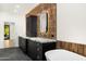 Elegant bathroom with dual sinks, marble countertops, copper-colored tiles, and a modern white soaking tub at 10041 N 52Nd Pl, Paradise Valley, AZ 85253