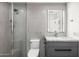 Modern bathroom with stylish gray vanity, gray tile, glass shower, and a toilet at 10041 N 52Nd Pl, Paradise Valley, AZ 85253