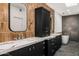 Modern bathroom with dual sinks, marble countertops, copper-colored tiles, and a standalone soaking tub at 10041 N 52Nd Pl, Paradise Valley, AZ 85253