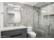 Modern bathroom with stylish gray vanity, gray tile, and glass shower at 10041 N 52Nd Pl, Paradise Valley, AZ 85253
