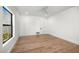 Bright, spacious bedroom with hardwood floors, a ceiling fan, large windows, and neutral walls at 10041 N 52Nd Pl, Paradise Valley, AZ 85253