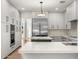Bright kitchen with stainless steel appliances, large island, and modern cabinetry at 10041 N 52Nd Pl, Paradise Valley, AZ 85253
