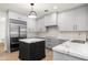 Modern kitchen with an island, stainless steel appliances, and light-colored cabinets at 10041 N 52Nd Pl, Paradise Valley, AZ 85253