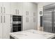 Stylish kitchen featuring stainless steel appliances, a double oven, and ample storage at 10041 N 52Nd Pl, Paradise Valley, AZ 85253