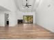 Open living room with fireplace, wood floors, and large windows to the yard at 10041 N 52Nd Pl, Paradise Valley, AZ 85253