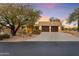 Desert landscape home with stucco exterior, two-car garage, and mature trees at 1300 Coyote Pass --, Carefree, AZ 85377