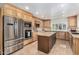 Modern kitchen with wood cabinets, granite island, and stainless steel appliances at 1300 Coyote Pass --, Carefree, AZ 85377