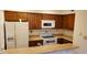 Galley kitchen with wood cabinets, and modern appliances at 1432 W Emerald Ave # 647, Mesa, AZ 85202