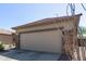 Attached two-car garage with neutral-colored door at 1713 W Morse Dr, Anthem, AZ 85086