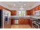 Modern kitchen with stainless steel appliances and wood cabinets at 1713 W Morse Dr, Anthem, AZ 85086