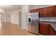 Kitchen boasts stainless steel refrigerator and wood cabinets at 1713 W Morse Dr, Anthem, AZ 85086