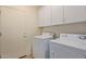 Laundry room with washer, dryer and upper cabinets at 1713 W Morse Dr, Anthem, AZ 85086