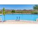 Inviting pool with lounge chairs and mountain views at 1713 W Morse Dr, Anthem, AZ 85086