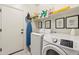 Convenient laundry room with washer, dryer, and shelving at 2428 E Runaway Bay Pl, Gilbert, AZ 85298