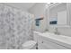 Bright bathroom featuring a decorative shower curtain, white vanity, and neutral wall color at 2533 W Hazelwood St # 3, Phoenix, AZ 85017