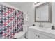 Bright bathroom featuring a decorative shower curtain, white vanity, and stylish mirror at 2533 W Hazelwood St # 3, Phoenix, AZ 85017