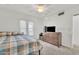 Bedroom featuring natural light, neutral carpet and walls, and a simple dresser with mounted television at 2533 W Hazelwood St # 3, Phoenix, AZ 85017
