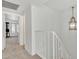 Bright hallway leading to an adjacent room, showcasing neutral carpeting and a decorative light fixture at 2533 W Hazelwood St # 3, Phoenix, AZ 85017