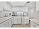 Bright kitchen with white cabinetry and neutral countertops with views to dining room at 2533 W Hazelwood St # 3, Phoenix, AZ 85017