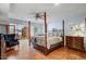 Spacious main bedroom with a large four-poster bed and hardwood floors at 2631 E Beekman Pl, Phoenix, AZ 85016