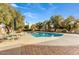 Inviting swimming pool surrounded by lush landscaping and patio furniture at 2631 E Beekman Pl, Phoenix, AZ 85016