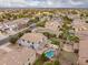 Aerial view of a home featuring a private backyard with a pool, fire pit, and lush landscaping at 3241 E Aris Dr, Gilbert, AZ 85298