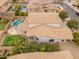 Aerial view of a home featuring a private backyard with a pool, fire pit, and lush landscaping at 3241 E Aris Dr, Gilbert, AZ 85298