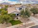 Aerial view of a well-manicured home with lush landscaping, a spacious driveway, and a mountain backdrop at 3241 E Aris Dr, Gilbert, AZ 85298