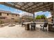 Backyard showcasing an outdoor kitchen, fire pit, and dining area with a stone counter and built-in seating at 3241 E Aris Dr, Gilbert, AZ 85298