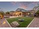 Backyard features a manicured lawn, pergola with string lights, and outdoor seating area, perfect for entertaining at 3241 E Aris Dr, Gilbert, AZ 85298