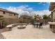 Open backyard with a seating area, firepit, table and chairs, and desert landscaping is ideal for relaxation at 3241 E Aris Dr, Gilbert, AZ 85298