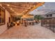 Inviting backyard patio with a pergola, seating area, built-in grill, and stylish pavers at 3241 E Aris Dr, Gilbert, AZ 85298
