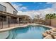 Resort-style backyard with a pool, fire pit, outdoor seating and dining areas, perfect for entertaining at 3241 E Aris Dr, Gilbert, AZ 85298