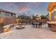 Paver patio, an inviting fire pit, built-in seating, and umbrella table create an ideal backyard space at 3241 E Aris Dr, Gilbert, AZ 85298
