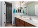 Bathroom featuring double sinks, wood cabinets, and framed mirrors at 3241 E Aris Dr, Gilbert, AZ 85298