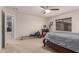 Spacious carpeted bedroom includes ceiling fan, multiple windows and an exercise machine at 3241 E Aris Dr, Gilbert, AZ 85298