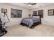 A spacious carpeted bedroom featuring a ceiling fan and large windows at 3241 E Aris Dr, Gilbert, AZ 85298