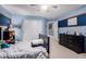 A carpeted bedroom featuring colorful accents, a bed, and a dresser at 3241 E Aris Dr, Gilbert, AZ 85298