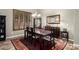 Dining room showcasing a dark wood table, decorative rug, chandelier, and window shutters at 3241 E Aris Dr, Gilbert, AZ 85298