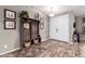 Welcoming entryway features stylish wood-look flooring and a functional hall tree with storage at 3241 E Aris Dr, Gilbert, AZ 85298