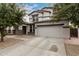 Two-story home featuring a spacious driveway and a two-car garage, framed by mature trees at 3241 E Aris Dr, Gilbert, AZ 85298