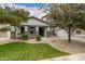Lovely single-Gathering home with stone accents, a well-manicured lawn, and a welcoming front porch at 3241 E Aris Dr, Gilbert, AZ 85298
