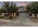 Lovely two-story home with a wide driveway, desert landscaping, and a cozy covered porch at 3241 E Aris Dr, Gilbert, AZ 85298
