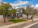 Attractive two-story home featuring mature trees, a well-kept lawn, and a spacious driveway at 3241 E Aris Dr, Gilbert, AZ 85298