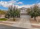 Two-story home features mature trees, an attached three-car garage, and a low-maintenance yard at 3241 E Aris Dr, Gilbert, AZ 85298